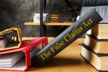 The False Claims Act FCA near the book and folders