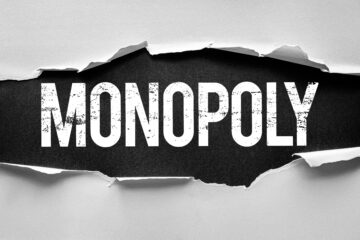 Monopoly written in white on a black background; business law orange county